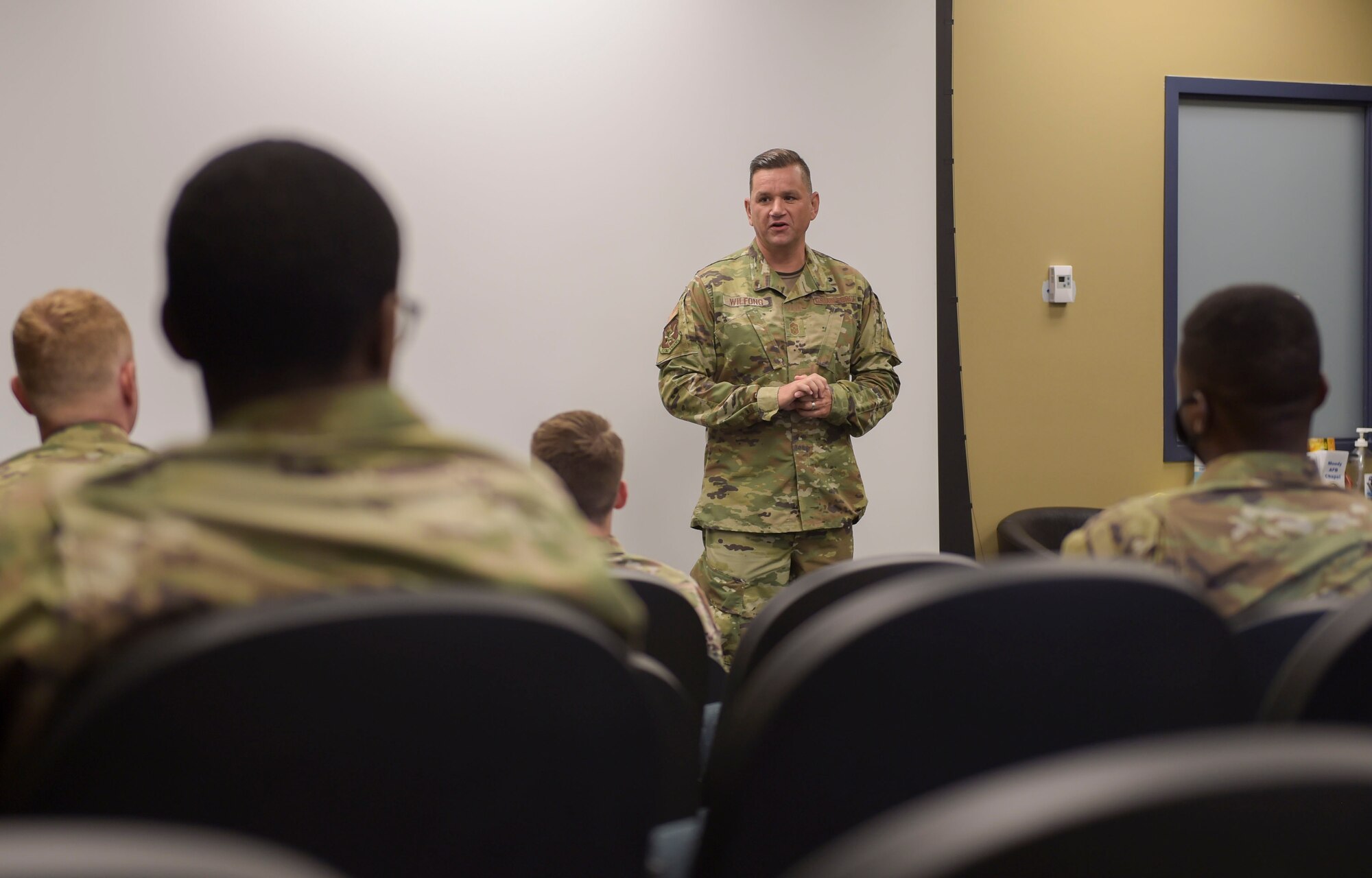 man talking in front of a group of people