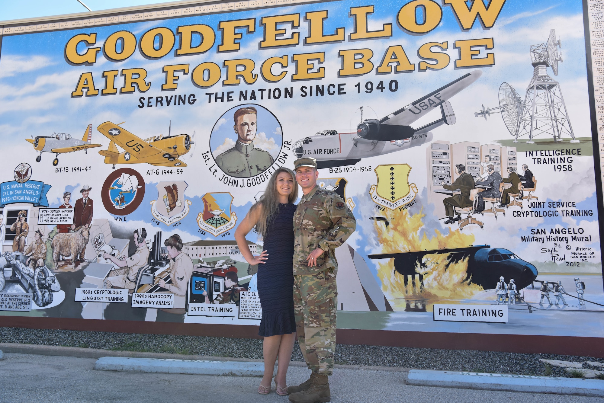 .S. Air Force Master Sgt. Corey Goodfellow, 388th Munitions Squadron commander’s support staff section chief and his wife, Nancy, pose for a photo near a Goodfellow mural in San Angelo, Texas, July 1, 2021. Master Sgt. Corey Goodfellow and his wife toured downtown San Angelo, Texas after the heritage ceremony. (U.S. Air Force photo by Senior Airman Jermaine Ayers)