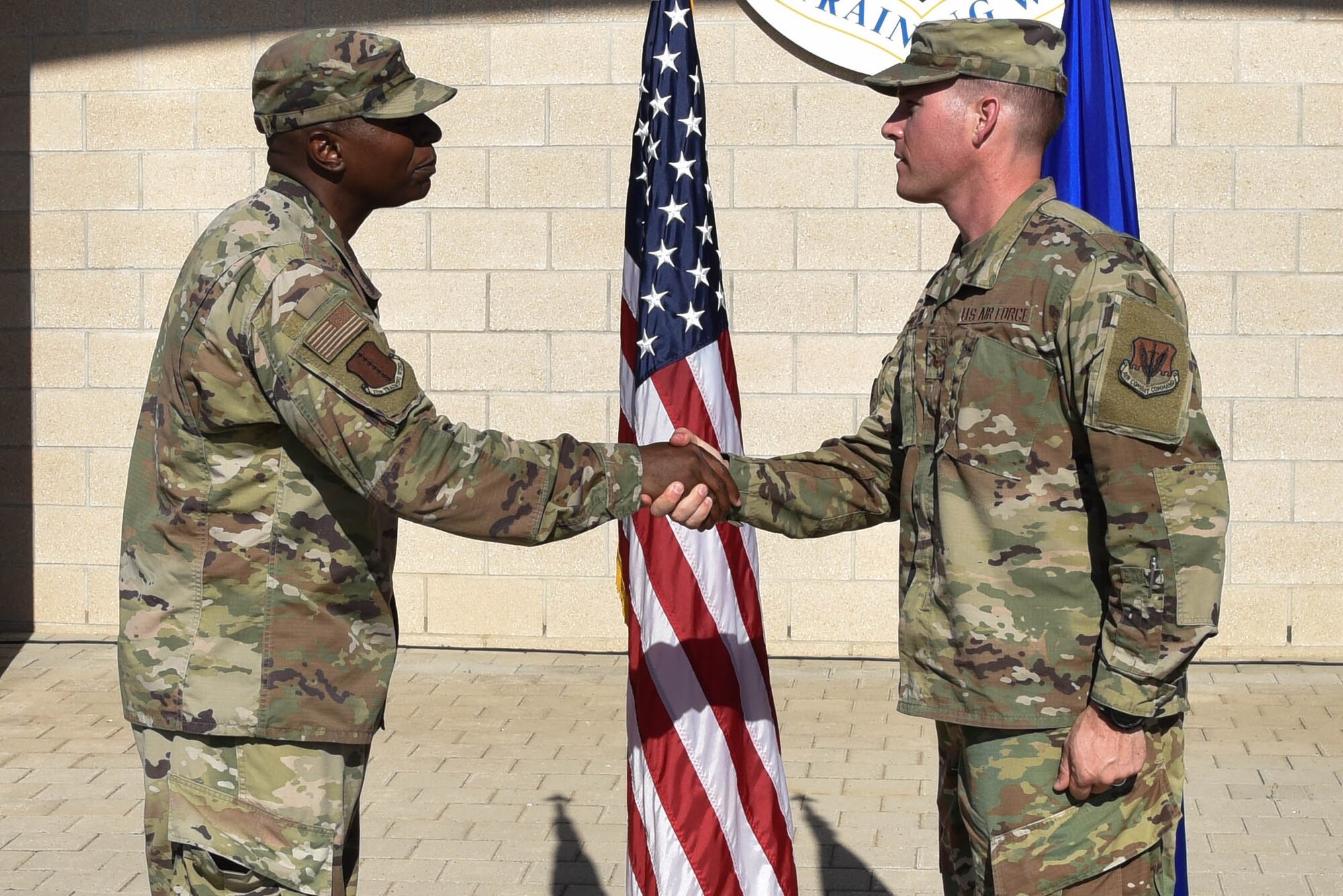 U.S. Air Force Col. James Finlayson, 17th Training Wing vice commander, coins Master Sgt. Corey Goodfellow, 388th Munitions Squadron commander’s support staff section chief on Goodfellow Air Force Base, Texas, July 1, 2021. Col. Finlayson awarded the 17th Training Wing coin to Master Sgt. Goodfellow as a token of appreciation for his crucial role in the Heritage Day Ceremony. (U.S. Air Force photo by Senior Airman Jermaine Ayers)