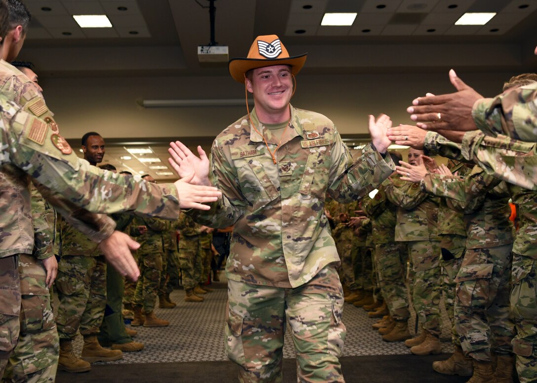 U.S. Air Force Staff Sgt. Eric Batham, 315th Training Squadron student, celebrates his achievement during the technical sergeant release party at the Event Center on Goodfellow Air Force Base, Texas, July 1, 2021. The Air Force-wide selection rate for technical sergeant was 26.94%. (U.S. Air Force photo by Senior Airman Abbey Rieves)