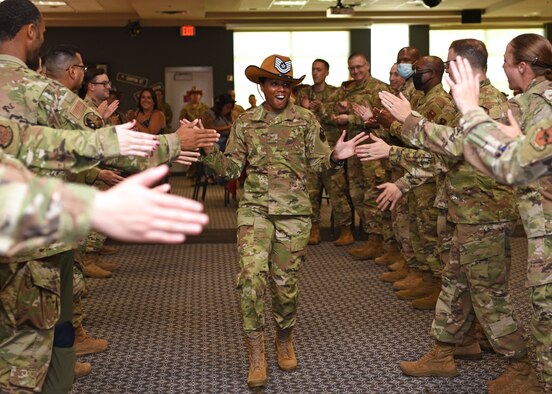 U.S. Air Force Col. James Finlayson, 17th Training Wing vice commander, presents Staff Sgt. Jackie Boykin, 315th Training Squadron instructor, a promotion certificate during the technical sergeant release party at the Event Center on Goodfellow Air Force Base, Texas, July 1, 2021. Air Force officials selected 9,422 of 34,973 eligible Staff Sergeants for promotion to Technical Sergeant for a selection rate of 26.94 percent. (U.S. Air Force photo by Senior Airman Abbey Rieves)