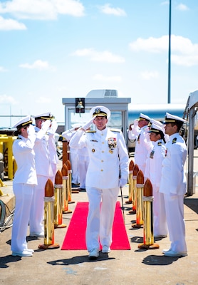 Vice Adm. David Kriete, center, deputy commander, U.S. Fleet Forces Command (USFFC) passes through the side boys during his retirement ceremony on board USS New Hampshire (SSN-78).
