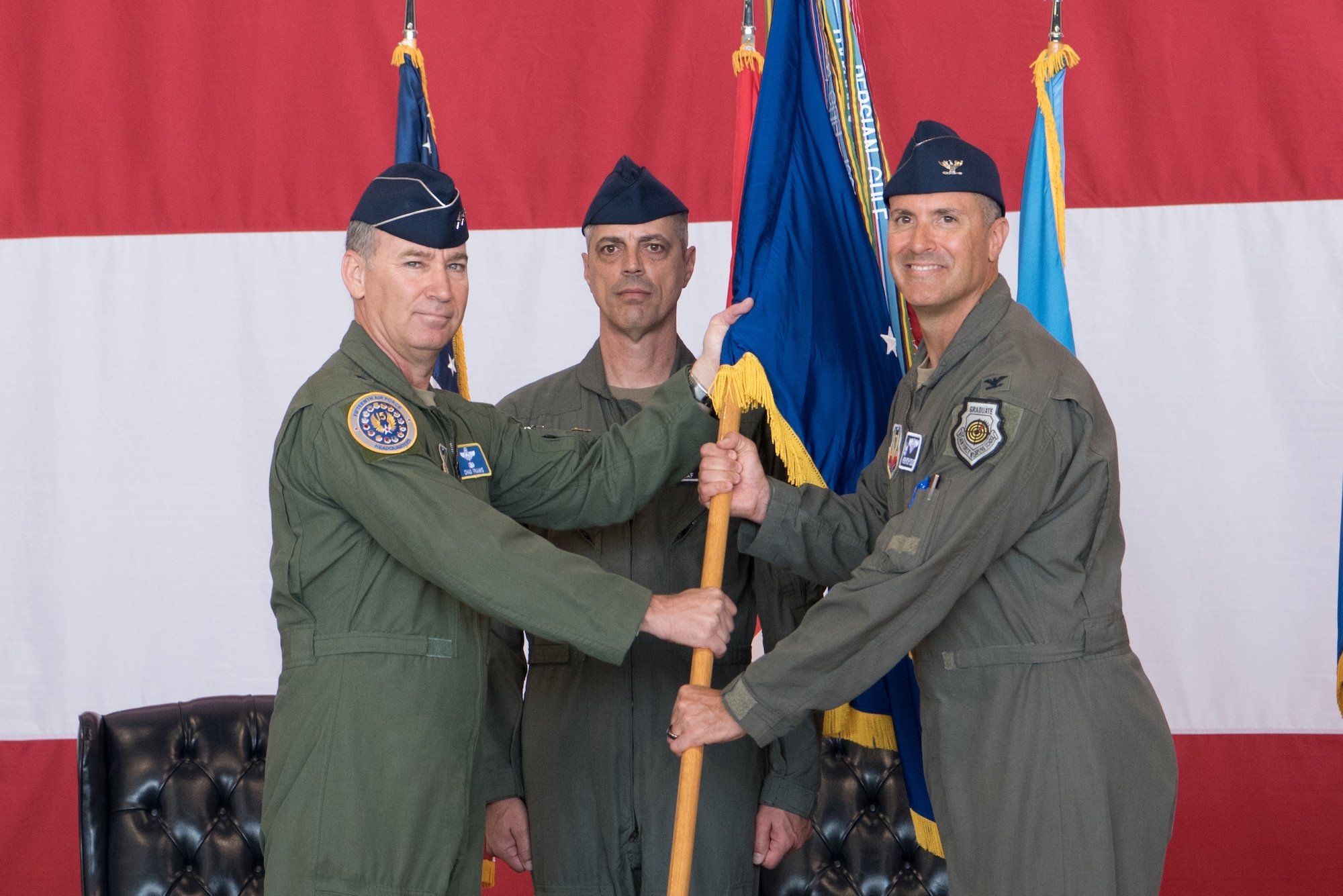 Three men holding a flag