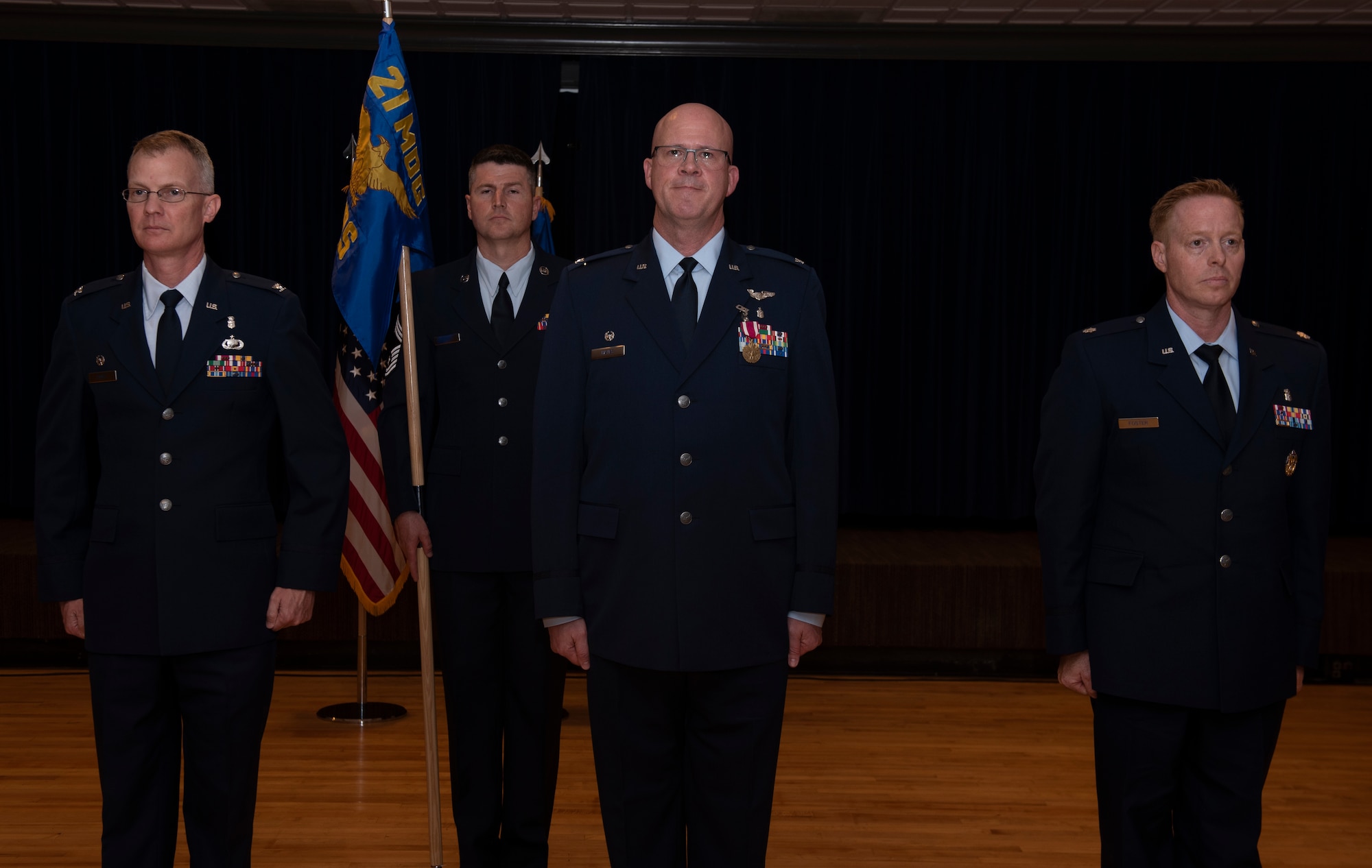 Commanders stand at attention during change of command