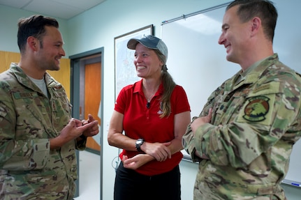 Alaska Air National Guardsmen of 210th Rescue Squadron, Tech. Sgt. Anthony Guedea (left) and Lt. Col. Michael Jordan meet with Iditarod musher Aliy Zirkle June 28, 2021, at Joint Base Elmendorf-Richardson, Alaska. Guedea and Jordan were part of the team that rescued Zirkle March 9 at the Iditarod Rohn checkpoint after she suffered a head injury.