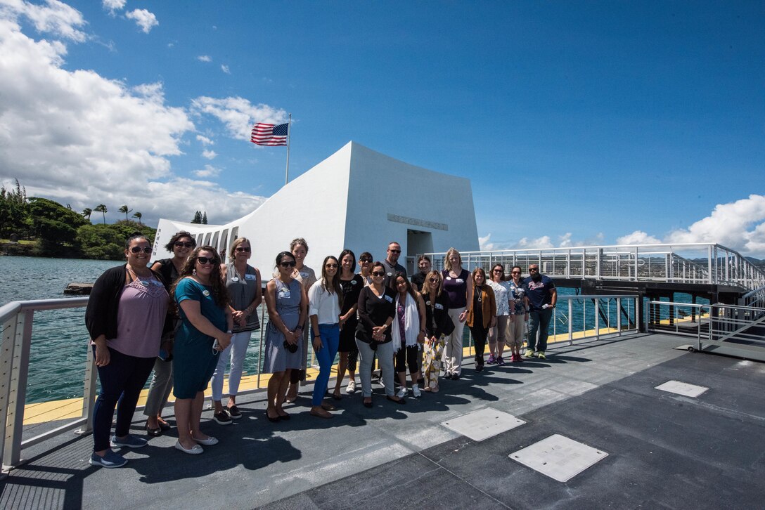 Participants of the 2021 Pacific Air Forces Squadron Commander Course pose for a photo before a barge tour of the Arizona Memorial at Pearl Harbor, Hawaii, June 24, 2021. The course enabled military spouses to discuss opportunities to solve challenges throughout the Pacific Air Forces’ area of responsibility and how to overcome them with innovative ideas. (U.S. Air Force photo by Staff Sgt. Hailey Haux)