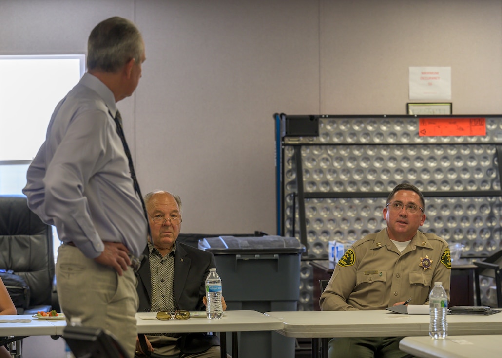 Captain Ronald Shaffer, Los Angeles County Sheriff's Department Palmdale Station commander, talks to Dr. David Smith, Plant 42 director, during a special meeting to discuss traffic safety at Plant 42 in Palmdale, California, June 30. (Air Force photo by Giancarlo Casem)