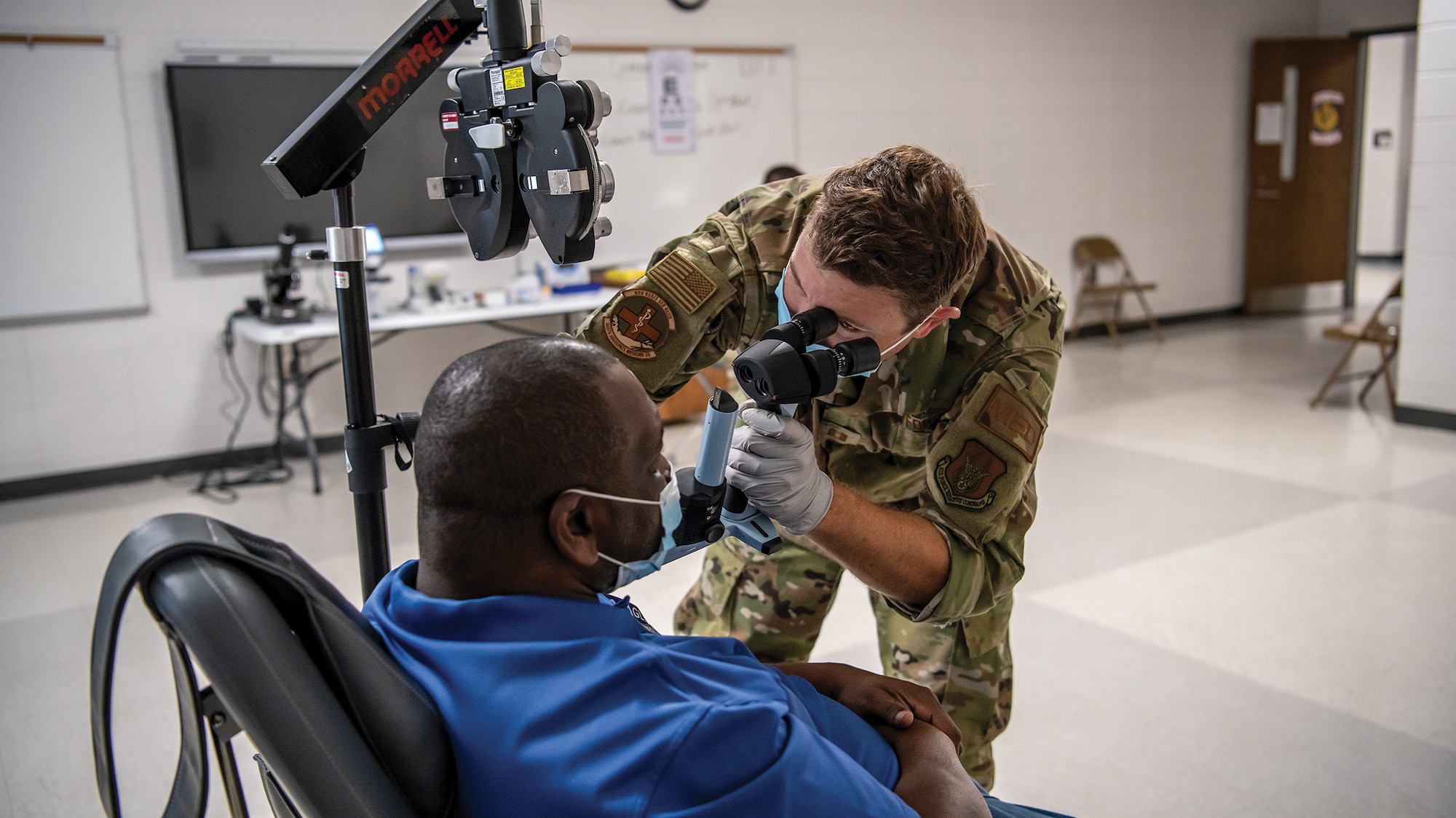 Capt. Adam Fannin, 445th Aerospace Medicine Squadron optometrist, assesses a patient at Jenkins County High School, Waynesboro, Georgia as part of East Central Georgia Medical Innovative Readiness Training, June 9, 2021.