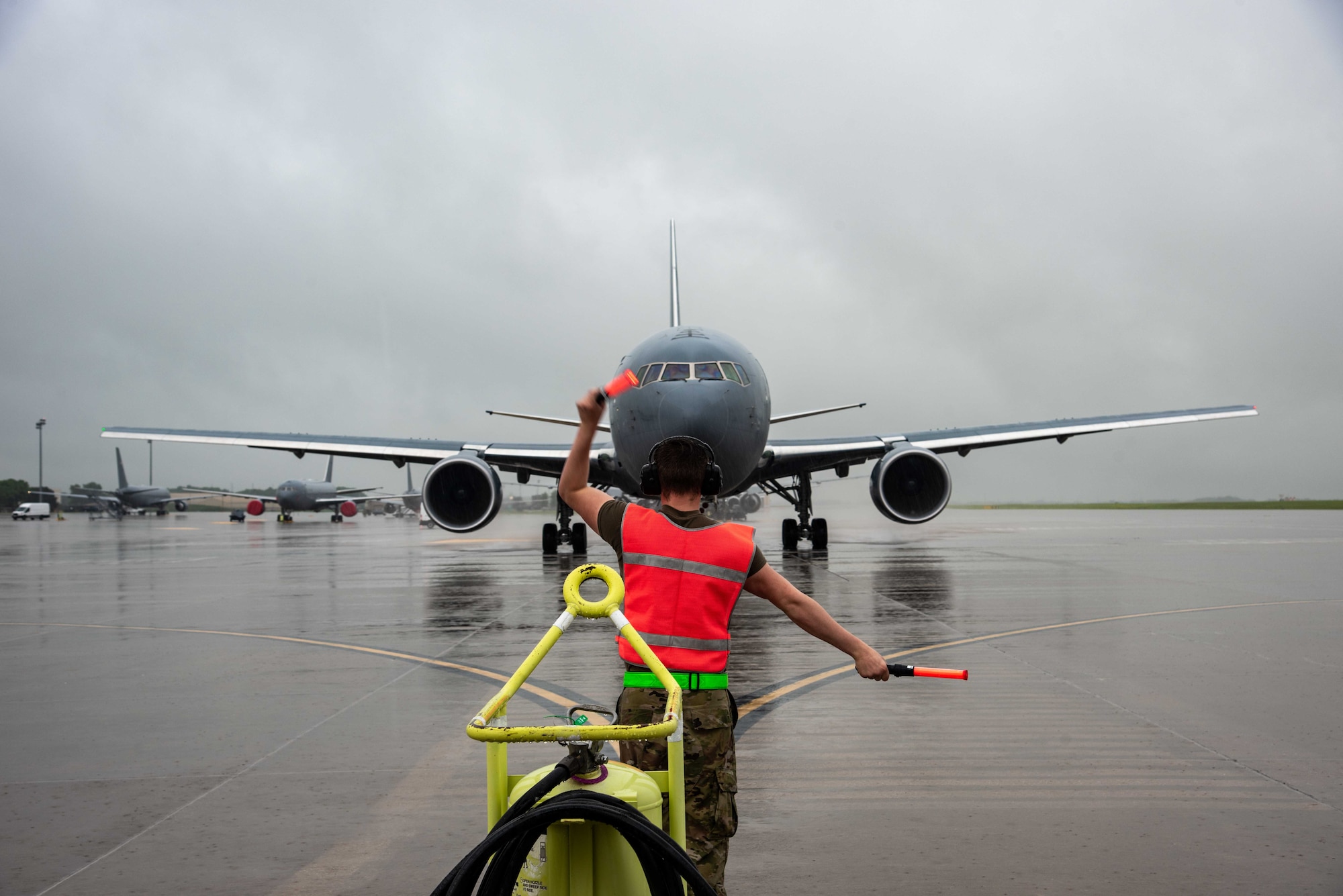 U.S. Air Force Airman 1st Class Reilly Avery, 22nd Aircraft Maintenance Squadron crew chief, marshals out a KC-46A Pegasus at McConnell Air Force Base, Kansas, June 30, 2021. The Aircraft delivered 60,000 pounds of fuel in support of Bat Wars training exercise. (U.S. Air Force photo by Airman 1st Class Zachary Willis)