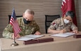 Brig. Gen. William Crane, the Adjutant General of the West Virginia National Guard, and Staff Brigadier Khalid Alkhayareen, Director of the International Forces Affairs Directory for Qatar's International Military Cooperation Authority, sign an expression of cooperation document between the State of West Virginia and the State of Qatar June 21, 2021, in Doha, Qatar. The expression of cooperation document signifies the official formalization of the partnership between West Virginia and Qatar as a part of the National Guard Bureau's State Partnership Program. (U.S. Air National Guard photo by Maj. Holli Nelson)