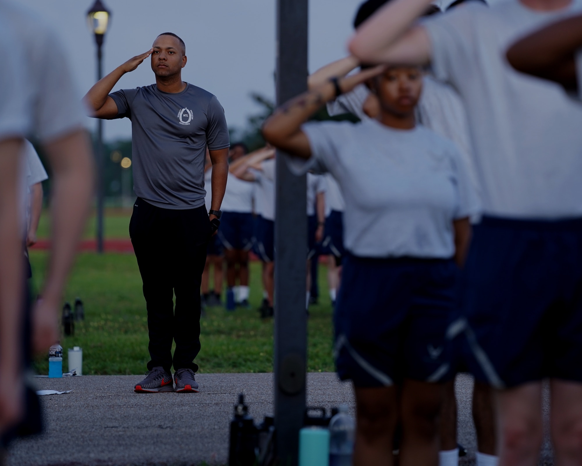 U.S. Air Force Tech. Sgt. Alvin Morris, 336th Training Squadron master military training leader, salutes before physical training at the Triangle track on Keesler Air Force Base, Mississippi, June 29, 2021. “An MTL consistently enforces standards of conduct and expectations to develop Airmen to be prepared to enter the operational Air Force,” said Morris. “We are the professional example for Airmen to emulate and first look at what a healthy leadership team looks like. It is our responsibility to inspire Airmen to take pride in serving and exhibit excellence in all we do.” (U.S. Air Force photo by Senior Airman Spencer Tobler)