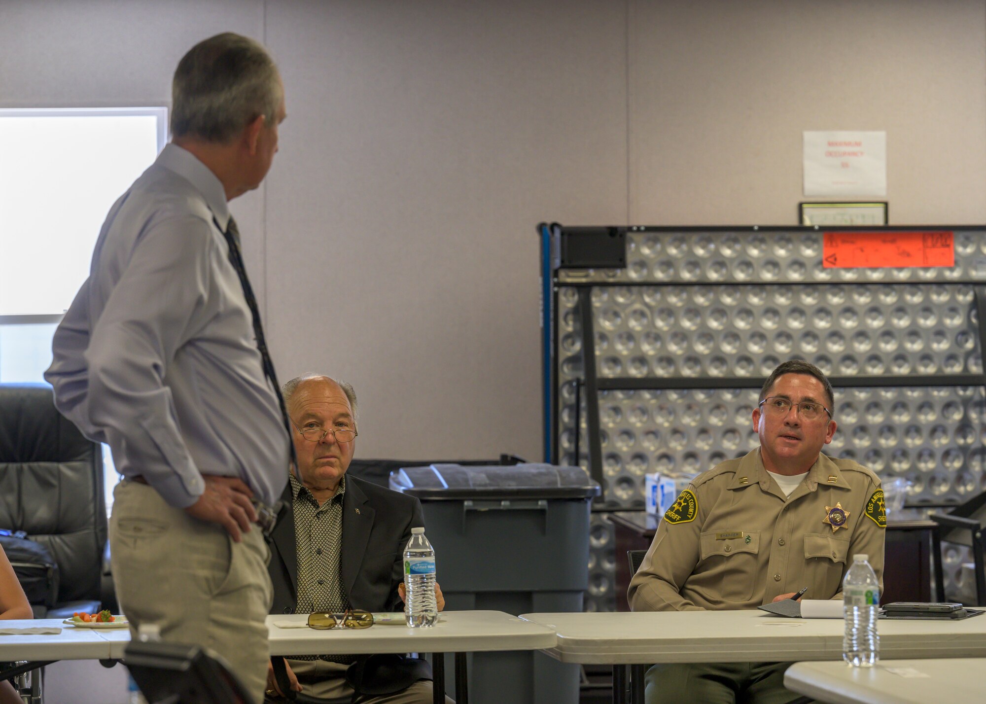 Captain Ronald Shaffer, Los Angeles County Sheriff's Department Palmdale Station commander, talks to Dr. David Smith, Plant 42 director, during a special meeting to discuss traffic safety at Plant 42 in Palmdale, California, June 30. (Air Force photo by Giancarlo Casem)
