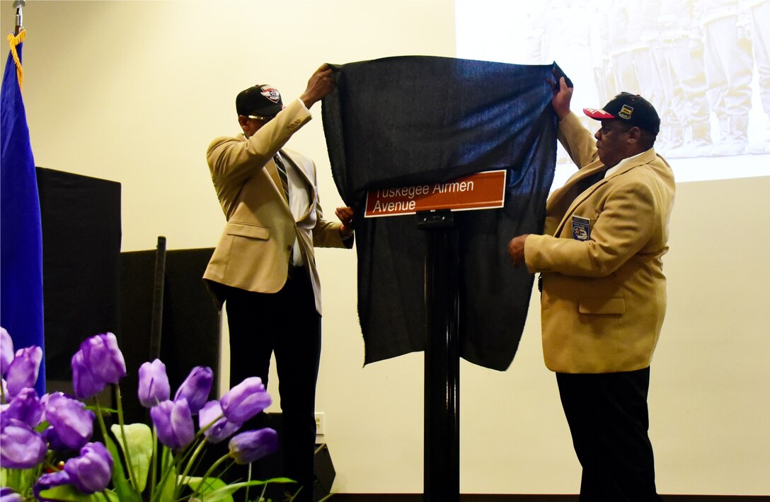 Retired Air Force Master Sgt. Vernon Martin, left, and Duvoice Gooden, members of the Tuskegee Airmen Inc. Charles B. Hall Chapter in Oklahoma City, unveil the Tuskegee Airmen Avenue street sign at Sheppard Air Force Base, Texas