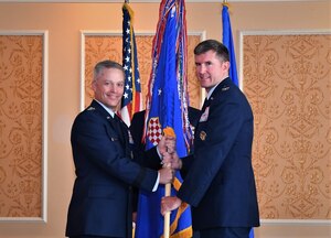 Photo of the passing of 363d ISR Wing guidon from one individual to another.