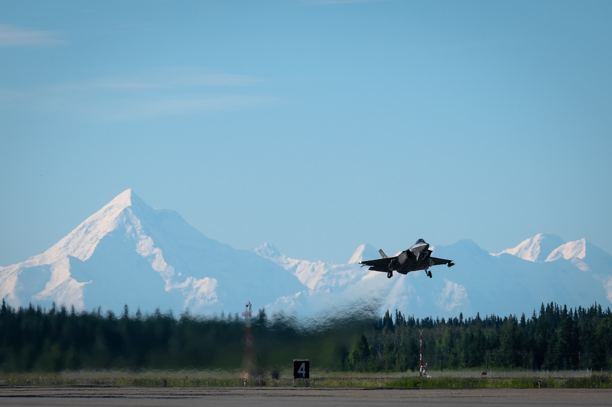 An aircraft takes off from a flightline