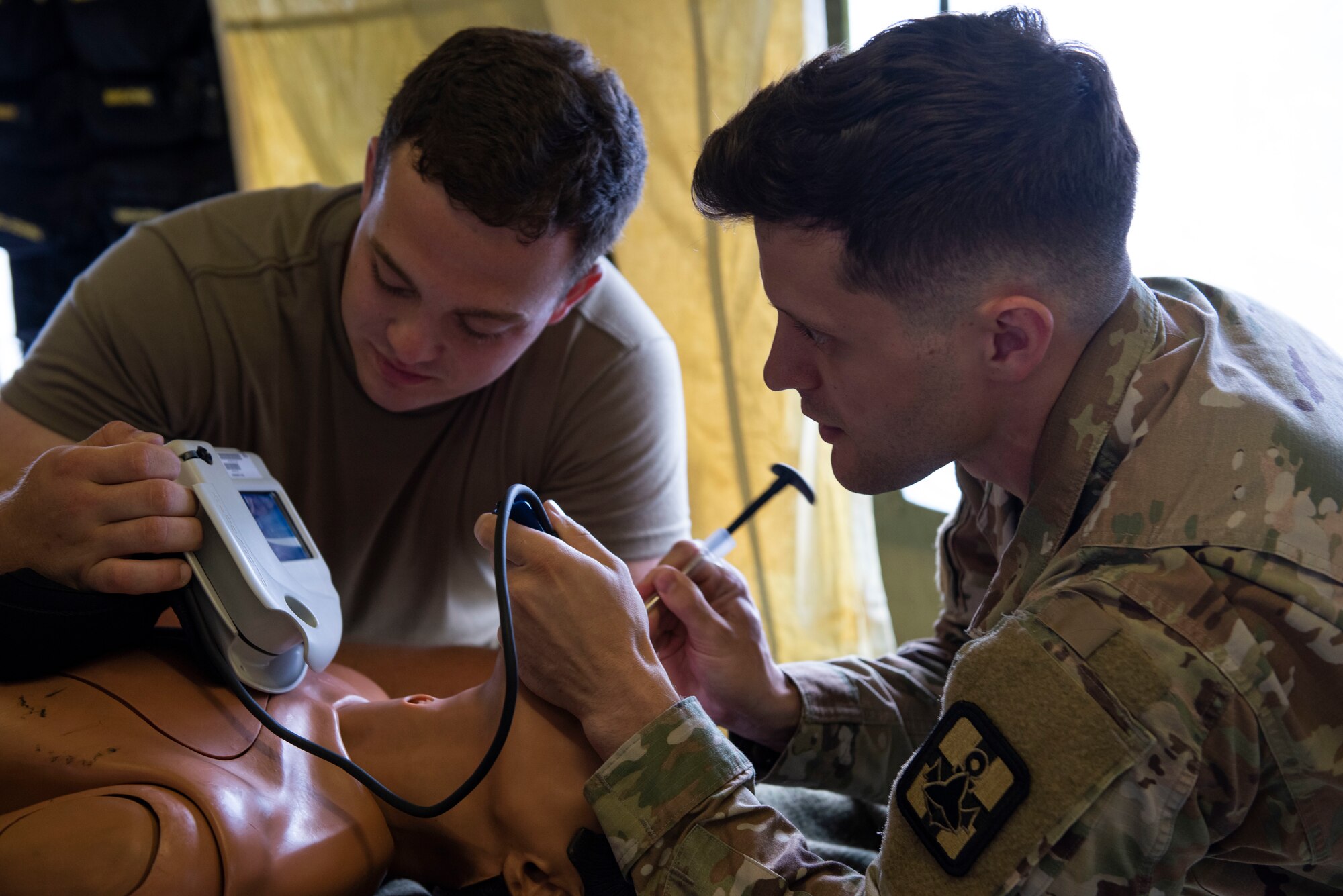 Soldiers from the 311th Field Hospital from Blacklick, Ohio, check an airway during an Army field exercise at Yokota Air Base, Japan, June 25, 2021. During the exercise, the 311th Field Hospital constructed a 32-bed hospital and performed a variety of simulated procedures to include installing IVs and providing sutures. (U.S. Air Force photo by Senior Airman Hannah Bean)
