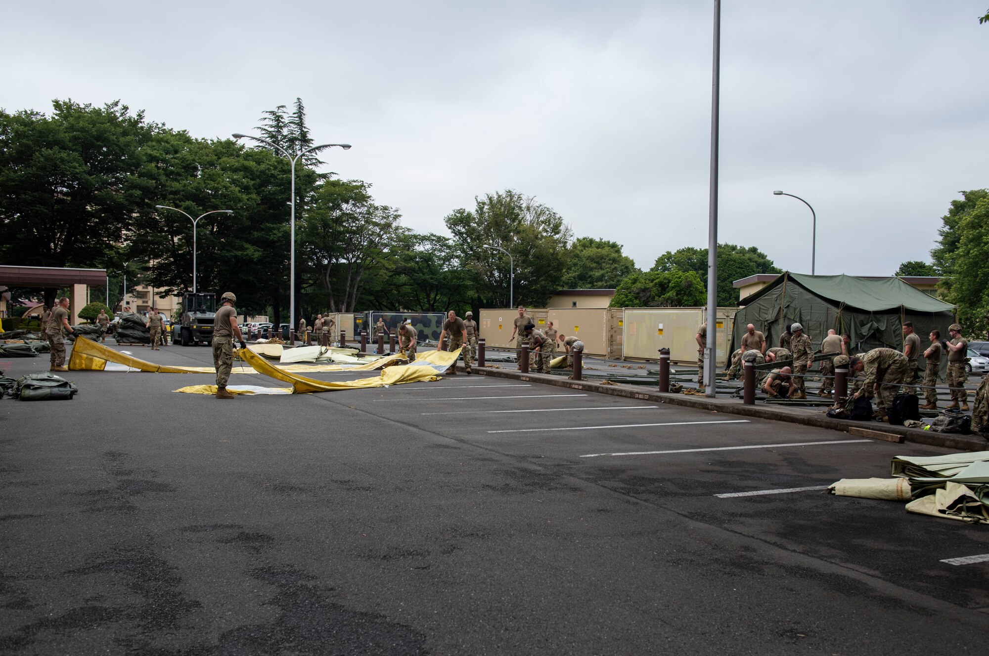 Soldiers from the 311th Field Hospital from Blacklick, Ohio, break down various equipment after an Army field exercise at Yokota Air Base, Japan, June 25, 2021. With the assistance of the 18th Medical Command and the 374th Airlift Wing, the 311th Field Hospital received the opportunity to mock forward deploy and practice setting up a 32-bed hospital in an unfamiliar location. (U.S. Air Force photo by Senior Airman Hannah Bean)