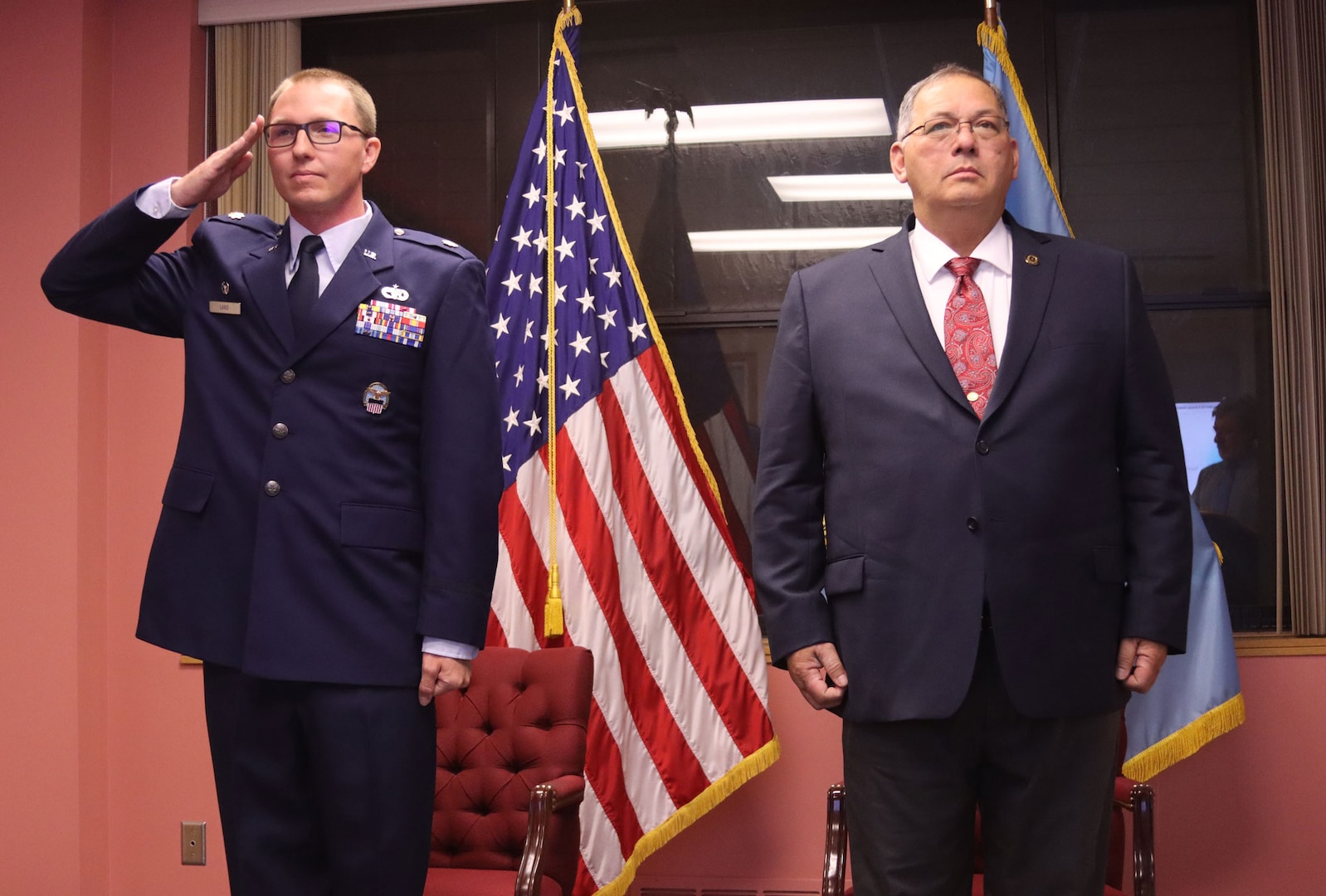 Air Force officer stands with a government civilian leader