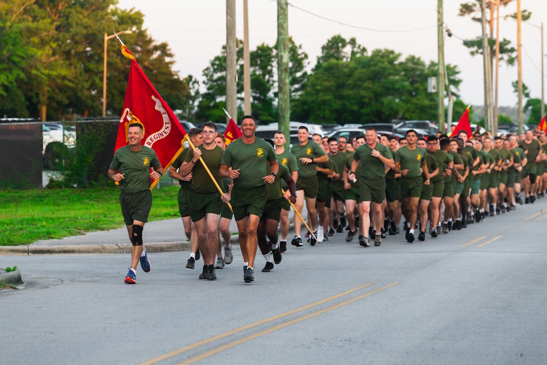 U.S. Marine Corps Col. David Mills, commanding officer of Combat Logistics Regiment 2 (CLR-2), and Sgt. Maj. Clifford Fincham, Sgt. Maj. of CLR-2, lead CLR-2 during a 2nd Marine Logistics Group run on Camp Lejeune, North Carolina, July. 1, 2021. The 2nd MLG held the training to boost morale and enhance unit cohesion around the unit. (U.S. Marine Corps photo by Lance Cpl. Zachary Zephir)