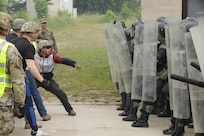 Albanian soldiers suppress simulated opposing forces during crowd control training as part of KFOR 29 at Hohenfels, Germany, June 26, 2021. Allies and partners take part in KFOR 29 training in order to increase interoperability and prepare the unit for peace support, stability and contingency operations in Kosovo in support of civil authorities. NATO has been leading the international peacekeeping force in Kosovo since June 1999 to ensure a secure, stable and multi-ethnic Kosovo. (U.S. Army photo by Spc. Enrique Moya)