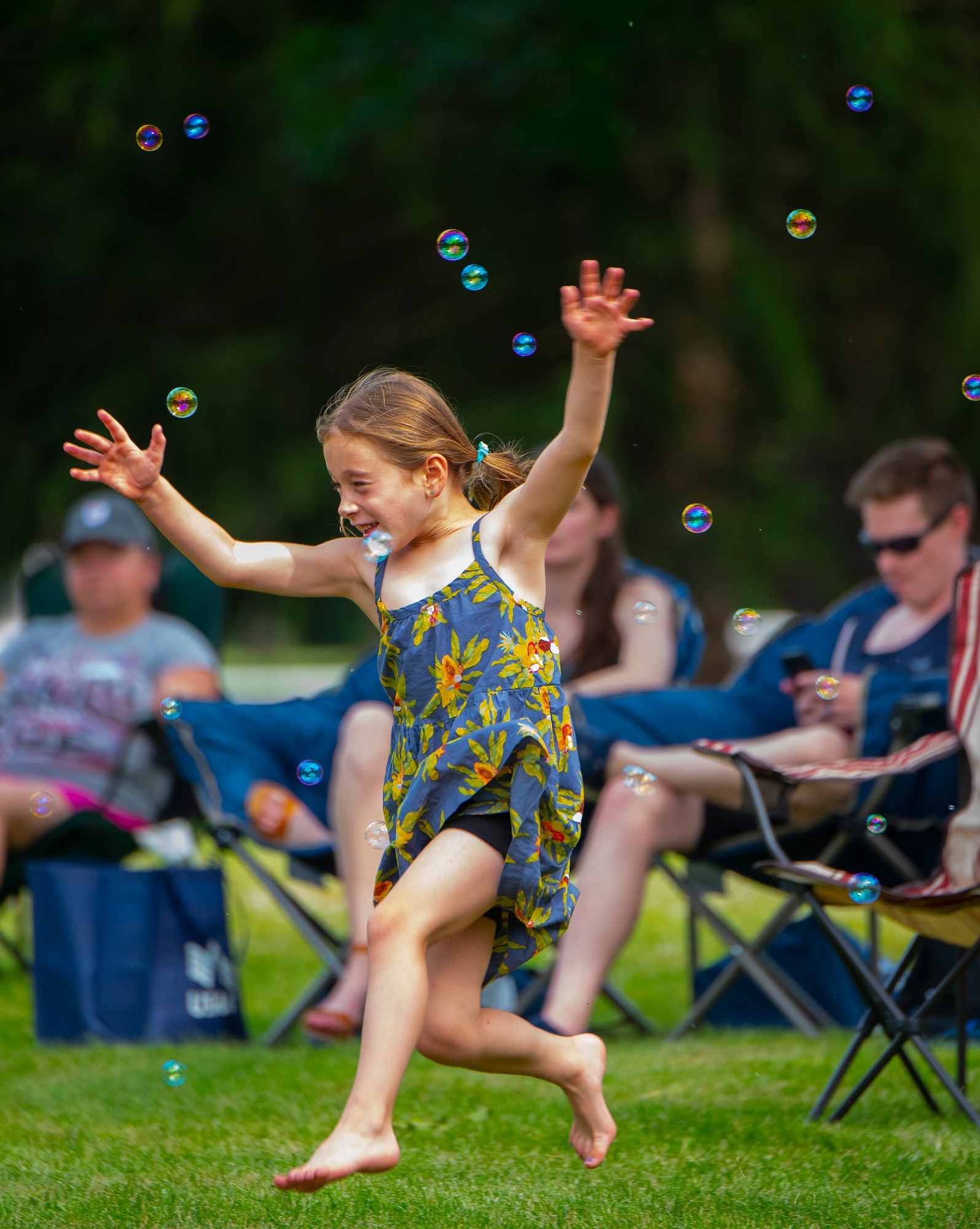 Alexandra Burger, 6, daughter of Col. Paul Burger, dances and chases bubbles June 24, 2021, at a block party sponsored by the 88th Force Support Squadron at Turtle Pond in the brick quarters historic district at Wright-Patterson Air Force Base, Ohio. The party, the first of a series of three through the summer, was free to all members of the Wright-Patt community. (U.S. Air Force photo by R.J. Oriez)