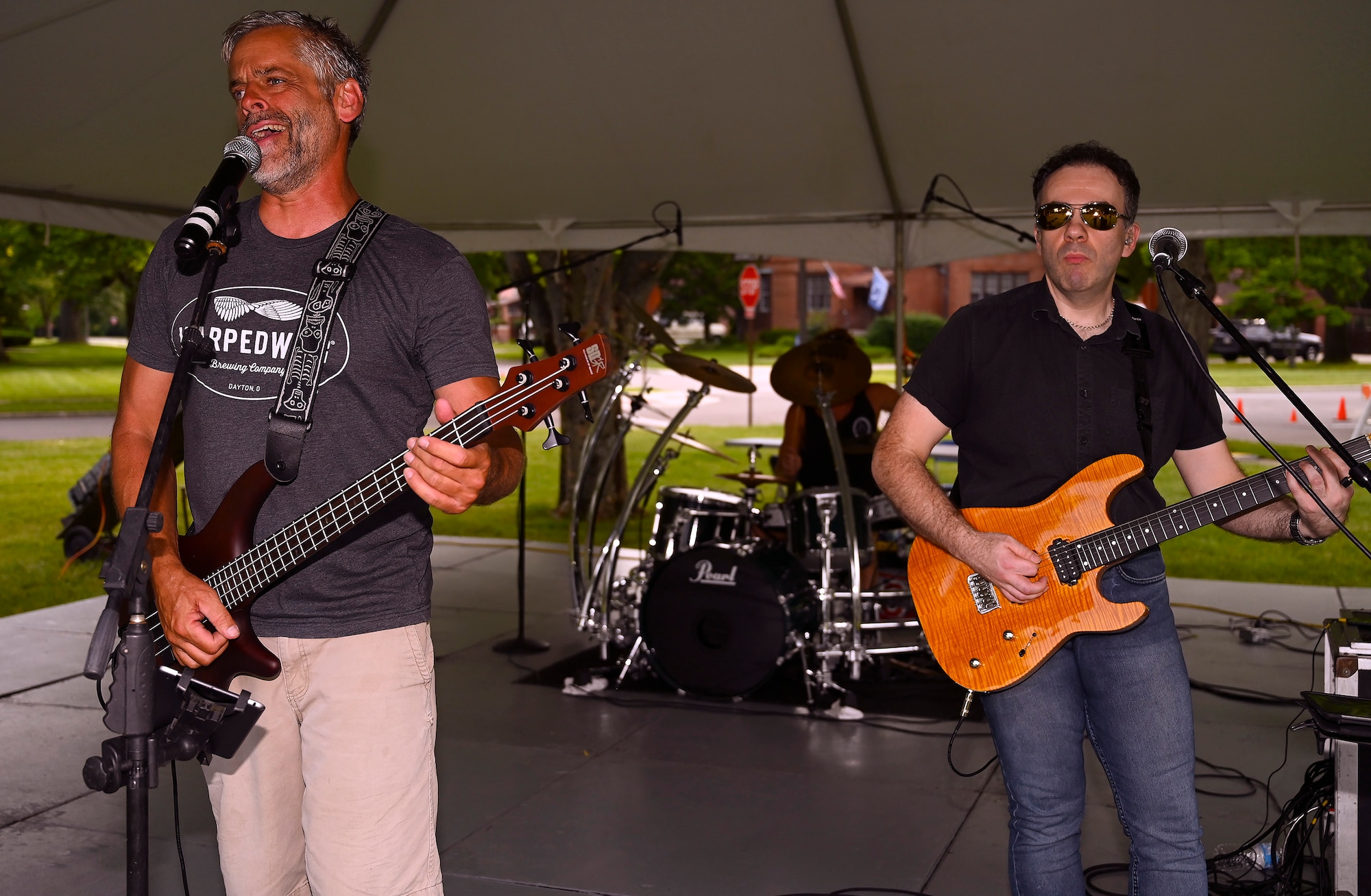 Dave Garwood (left) provides lead vocals and bass while David Hurley plays guitar for Velvet Crush during the first Block Party Concert at Turtle Pond in the brick quarters historic district June, 24, 2021, at Wright-Patterson Air Force Base, Ohio. Other block parties scheduled by the 88th FSS are set to include performances by Stranger, a band specializing in the hits of the 1980s, and Parrots of the Caribbean, which is a salute to Jimmy Buffett. (U.S. Air Force photo by R.J. Oriez)