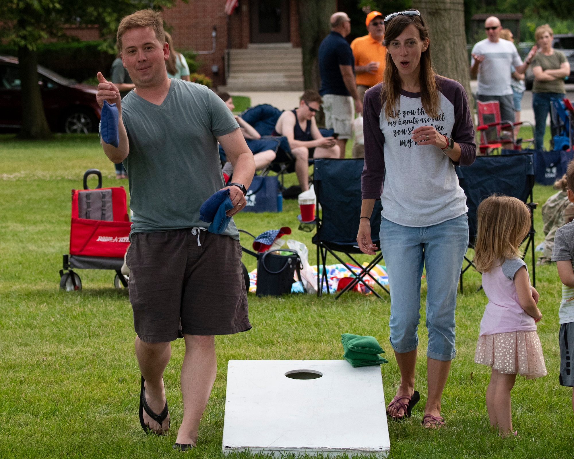 Maj. Jacob Collie, and his wife Tanya, play cornhole at a block party sponsored by the 88th Force Support Squadron June 24, 2021, at the Turtle Pond in the brick quarters historic district at Wright-Patterson Air Force Base, Ohio. The event featured music, games, food and sponsor booths and gave the Wright-Patt community an opportunity to get out and socialize. (U.S. Air Force photo by R.J. Oriez)