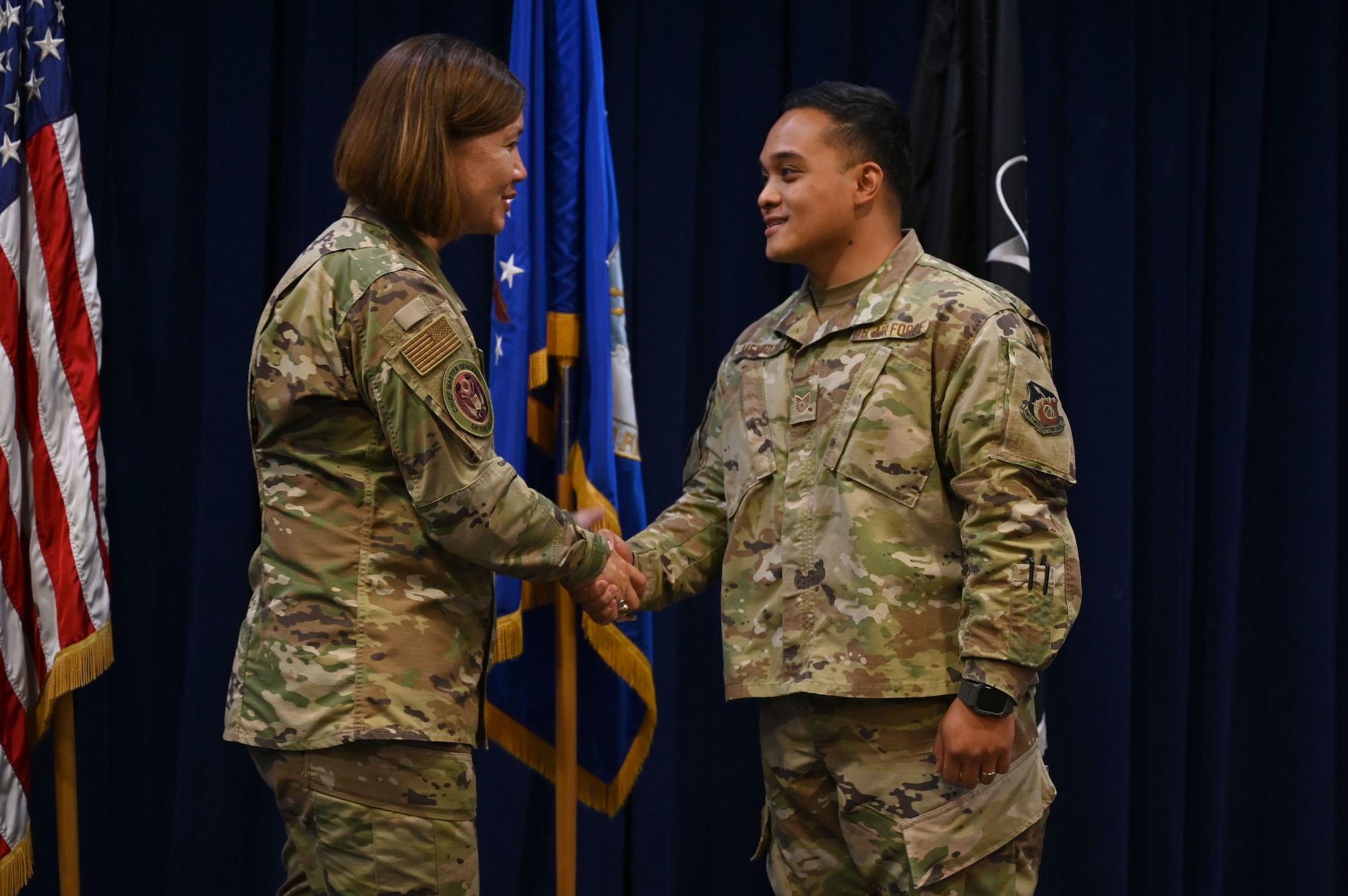 Chief Master Sgt. of the Air Force JoAnne S. Bass coins Tech. Sgt. Darwincarl Mendoza, 61st Medical Squadron bio environmental engineer, after an enlisted all call July 1, 2021, at Los Angeles Air Force Base, California. Bass thanked Space and Missile Systems Center and 61st Air base Group enlisted members for their dedication to the U.S. Air and Space Force and their perspective and honest feedback on service-wide initiatives. (U.S. Space Force photo by Staff Sgt. Andrew Moore)