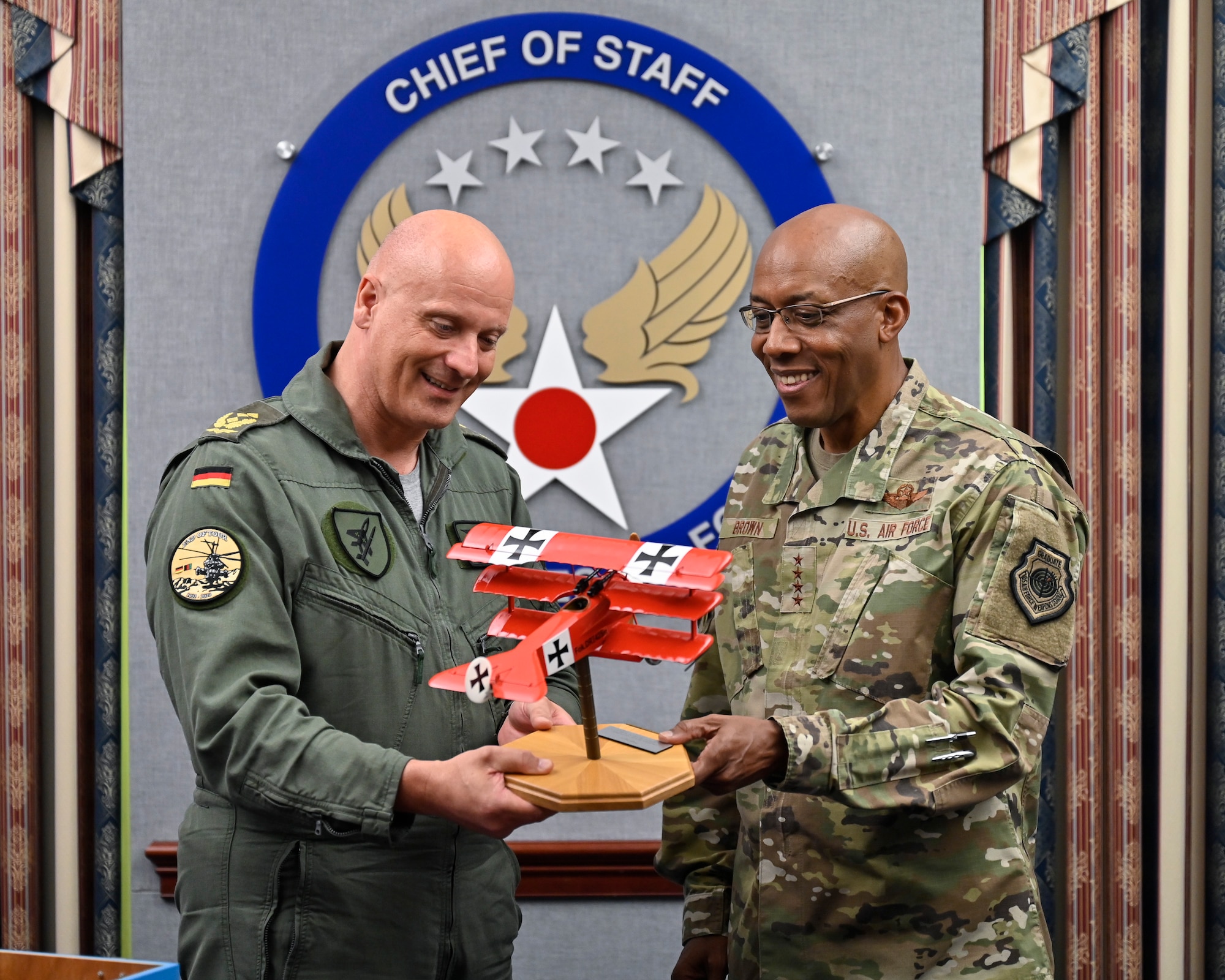 Lt. Gen. Ingo Gerhartz, inspector of the German air force, presents a gift to Air Force Chief of Staff Gen. CQ Brown, Jr. after a meeting