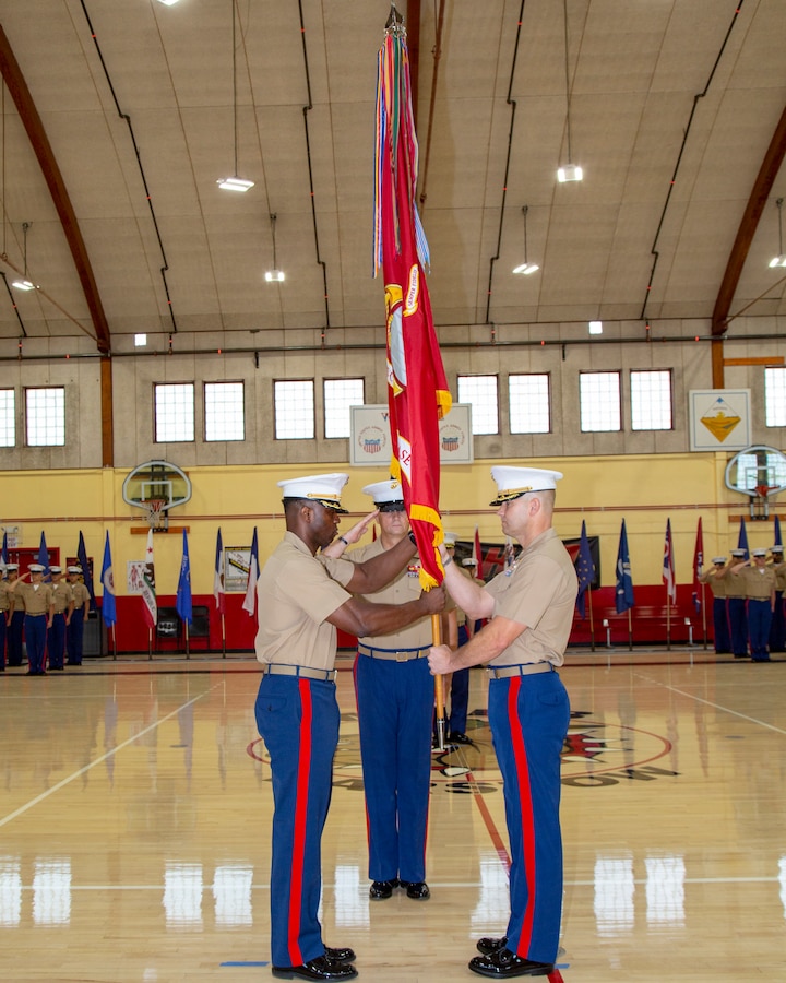 Colonel Gregory B. Pace receives the colors as he assumes command from Col. Craig C. Clemans, during the Change of Command ceremony held aboard Marine Corps Logistics Base Barstow, California, July 1. Colonel Pace comes to Barstow from his latest role as the G4 with 2d Marine Expeditionary Brigade, II Marine Expeditionary Force.