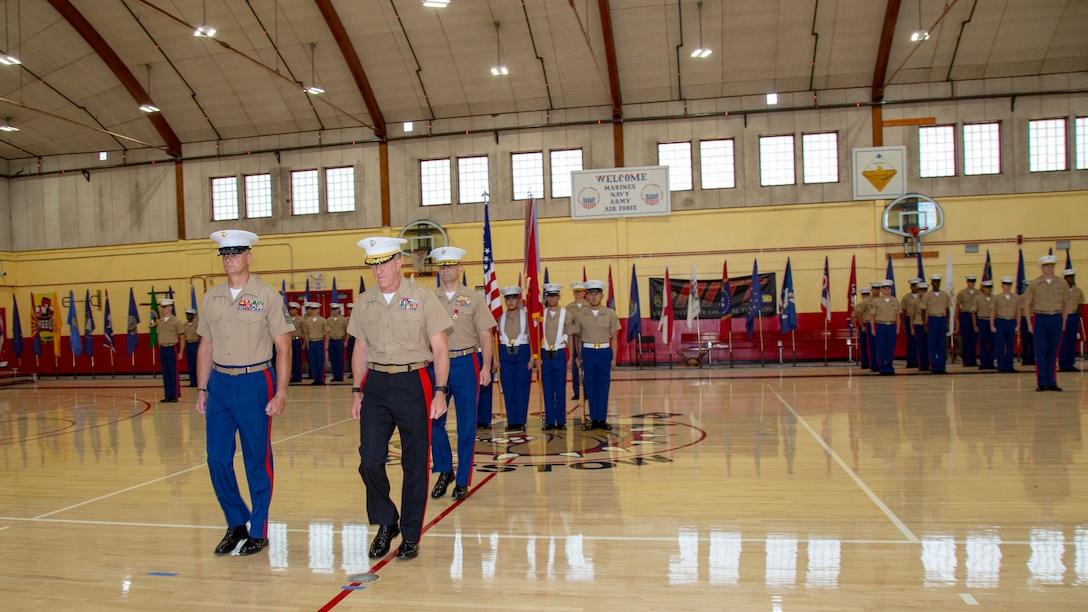 Brigadier General Jason G. Woodworth, commanding general, Marine Corps Installations West, Marine Corps Base Camp Pendleton, exits with Sgt. Maj. Edward C. Kretschmer, MCLB Barstow base sergeant major, and Col. Craig C. Clemans, outgoing base commander, after presenting Clemans with a Legion of Merit medal as part of the Change of Command ceremony held aboard Marine Corps Logistics Base Barstow, California, July 1. Clemans will be assuming the role of Chief of Staff for Logistics Command aboard Marine Corps Logistics Base Albany, Georgia.
