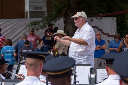 Retired U.S. Army Chief Warrant officer 4 Charles Booker, bandmaster for 5th Army Band from 1972-1976, leads “Fort Sam’s Own” 323d Army Band and 313th Army Band, a U.S. Army Reserve band during an Independence Day concert held at The Alamo, July 2, 2021. Booker was spontaneously asked to lead the concert during the last song, “Stars and Stripes Forever.” (U.S. Army Photo by Bethany Huff)