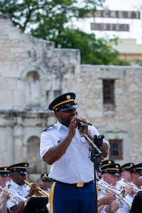 Staff Sgt. Randy Holmes, assigned to “Fort Sam’s Own” 323d Army Band, sings “Armed Forces Salute,” during an Independence Day concert held at The Alamo, July 2, 2021. The 323rd performed with the 313th Army Band, a U.S. Army Reserve band from Redstone Arsenal in Huntsville, Alabama. (U.S. Army Photo by Bethany Huff)