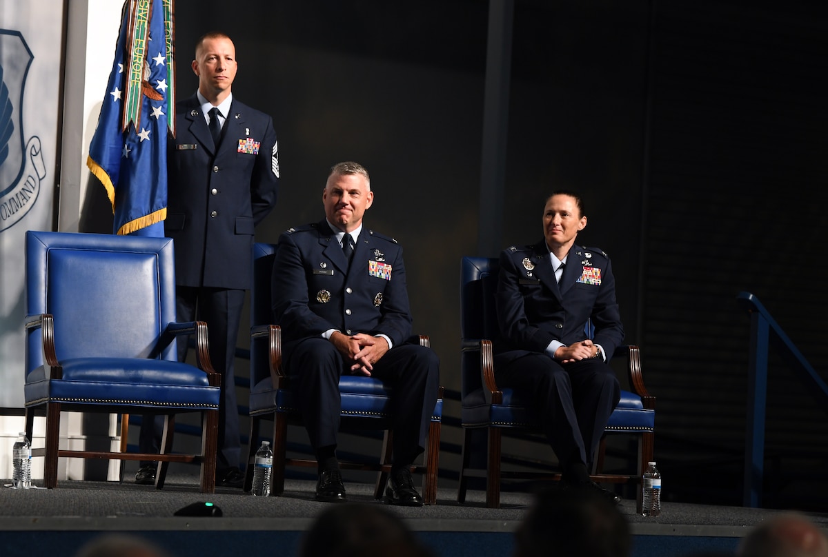Photo shows Col Droz and Col Moore sitting on stage.