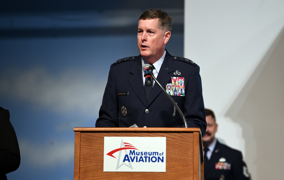 Photo shows Col. Kirkland standing behind podium.