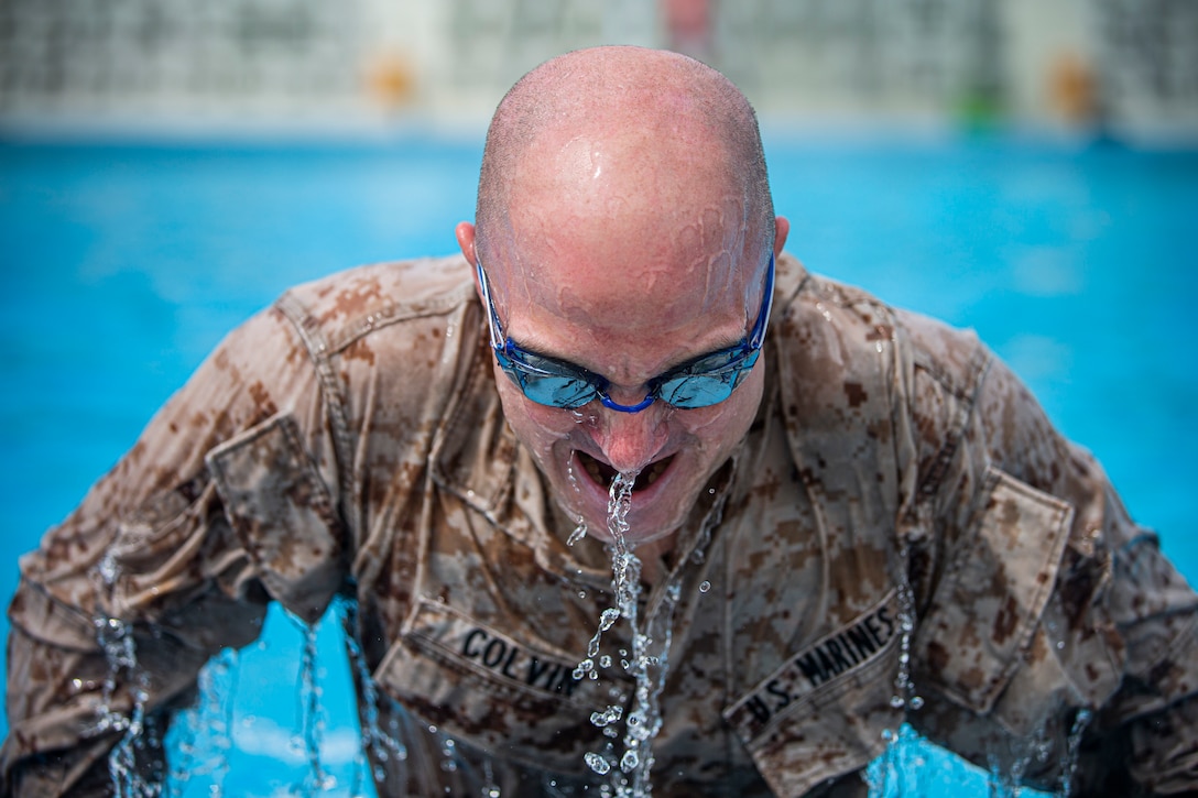 U.S. Marine Corps Staff Sgt. Joseph Colvin, the storage staff noncommissioned officer in charge with Ammunition Company, 3rd Supply Battalion, Combat Logistics Regiment 35, 3rd Marine Logistics Group, III Marine Expeditionary Force, conducts push-ups during the water survival advanced course on Marine Corps Air Station Futenma, Okinawa, Japan, June 17, 2021. WSA is the highest swim qualification Marines and sailors can obtain before moving onto the next echelon of becoming a Marine Corps Instructor of Water Survival. The week-long course kicks off with a water survival pre screening event, and the remainder of the course consists of numerous endurance swims, life-saving techniques and applications, physical and mental conditioning, and countless swimming drills to ensure students have the confidence to not only maintain themselves but others’ lives while in the water. Colvin is a native of Philadelphia, Pennsylvania.