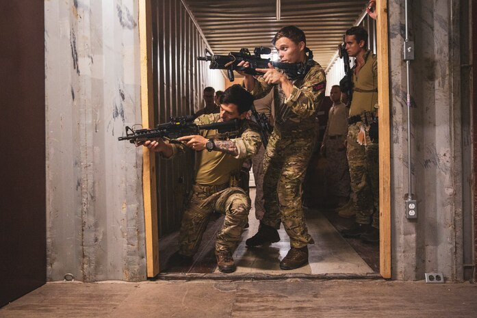 Royal Marines assigned to Royal Marine Boat Team simulate clearing a room during close-quarters battle training with U.S. Marines assigned to Fleet Anti-Terrorism Security Team Central Company onboard Naval Support Activity Bahrain, June 19. FASTCENT provides expeditionary anti-terrorism and security forces to embassies, consulates, and other vital national assets throughout the U.S. Central Command area of responsibility.