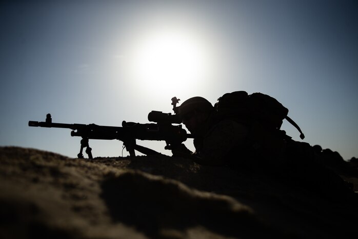 A U.S. Marine with 2nd Battalion, 1st Marine Regiment, assigned to Special Purpose Marine Air-Ground Task Force – Crisis Response – Central Command, provides security with his M240B medium machine gun during Crisis Response Exercise II in Kuwait, June 19, 2021. CRX II is a long range assault in which Marines simulate taking over and occupying a forward operations base in a hostile environment.  The SPMAGTF-CR-CC is a crisis response force, prepared to deploy a variety of capabilities across the region.