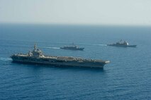 Aircraft carrier USS Dwight D. Eisenhower (CVN 69), left, Egyptian Navy guided-missile frigate ENS Taba (FFG 916), center, and guided-missile cruiser USS Vella Gulf (CG 72) conduct a passing exercise in the Red Sea, June 29. The Eisenhower Carrier Strike Group is deployed to the U.S. 5th Fleet area of operations in support of naval operations to ensure maritime stability and security in the Central Region, connecting the Mediterranean and Pacific through the western Indian Ocean and three strategic choke points.