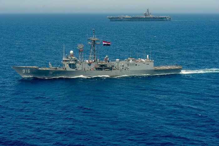 Egyptian Navy guided-missile frigate ENS Taba (FFG 916), front, conducts a passing exercise with aircraft carrier USS Dwight D. Eisenhower (CVN 69) in the Red Sea, June 29. The Eisenhower Carrier Strike Group is deployed to the U.S. 5th Fleet area of operations in support of naval operations to ensure maritime stability and security in the Central Region, connecting the Mediterranean and Pacific through the western Indian Ocean and three strategic choke points.