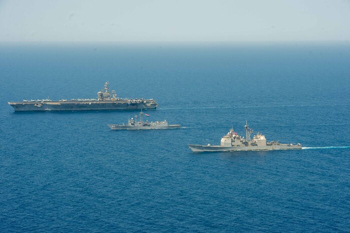 Aircraft carrier USS Dwight D. Eisenhower (CVN 69), left, Egyptian Navy guided-missile frigate ENS Taba (FFG 916), center, and guided-missile cruiser USS Vella Gulf (CG 72) conduct a passing exercise in the Red Sea, June 29. The Eisenhower Carrier Strike Group is deployed to the U.S. 5th Fleet area of operations in support of naval operations to ensure maritime stability and security in the Central Region, connecting the Mediterranean and Pacific through the western Indian Ocean and three strategic choke points.