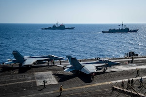Sailors conduct flight operations on the flight deck of aircraft carrier USS Dwight D. Eisenhower (CVN 69) during a passing exercise with Egyptian Navy guided-missile frigate ENS Taba (FFG 916), right, and guided-missile cruiser USS Vella Gulf (CG 72) in the Red Sea, June 29. The Eisenhower Carrier Strike Group is deployed to the U.S. 5th Fleet area of operations in support of naval operations to ensure maritime stability and security in the Central Region, connecting the Mediterranean and Pacific through the western Indian Ocean and three strategic choke points.