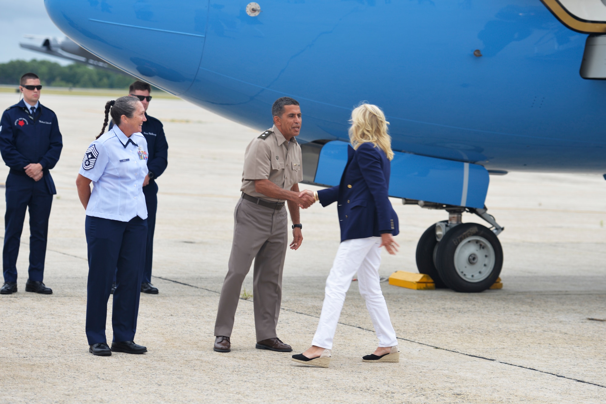 Maj. Gen. David Mikolaities, right, the Adjutant General for the New Hampshire National Guard, and Chief Master Sgt. Erica Rhea, left, 157th Air Refueling Wing command chief, greet First Lady Dr. Jill Biden as she arrives at Pease Air National Guard Base, July 3.