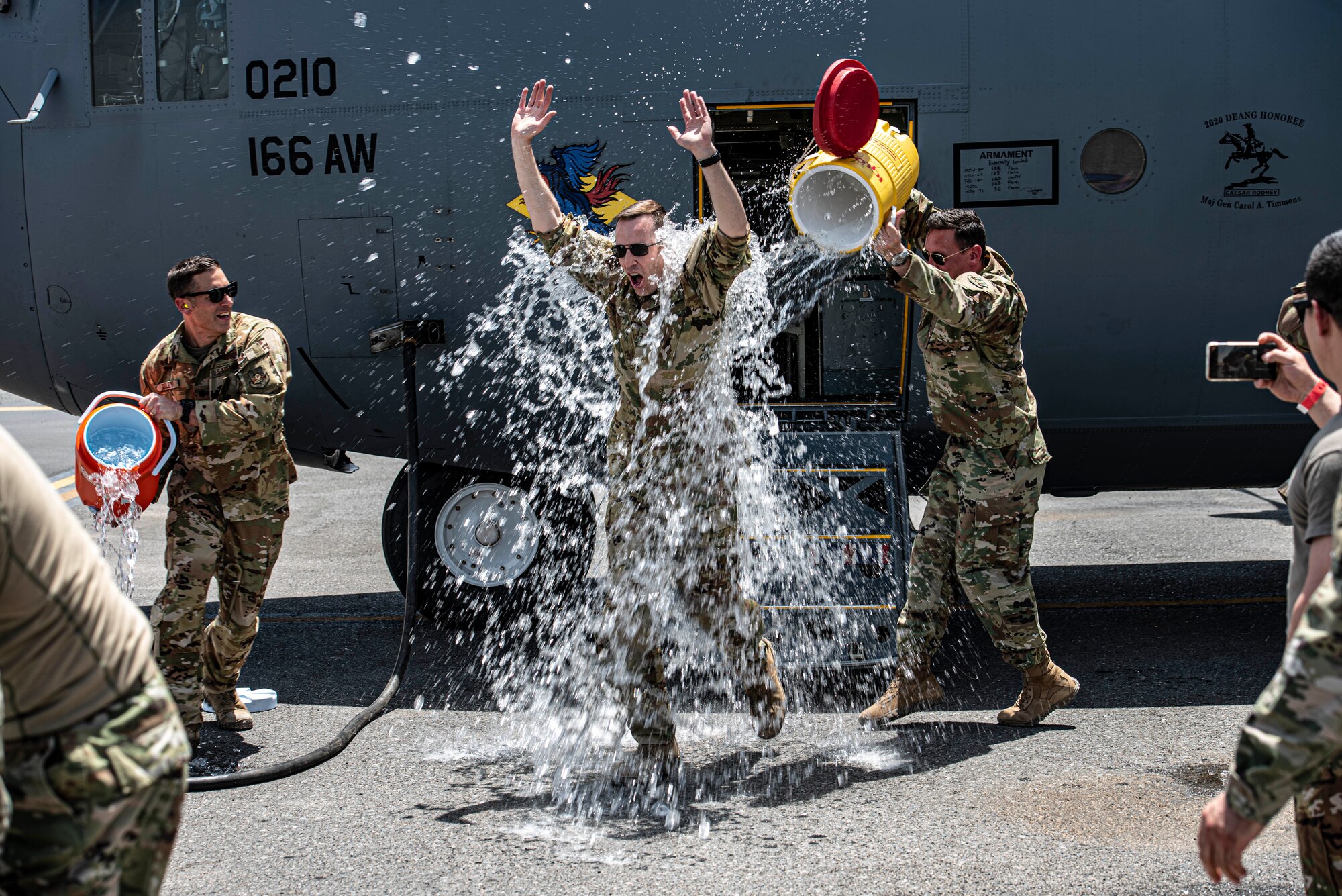 Members of the 386th Air Expeditionary Wing dump coolers of ice water on Col. Philip Shea, 407th Air Expeditionary Group commander, after his “fini flight” at Ali Al Salem Air Base, Kuwait, July 4, 2021.