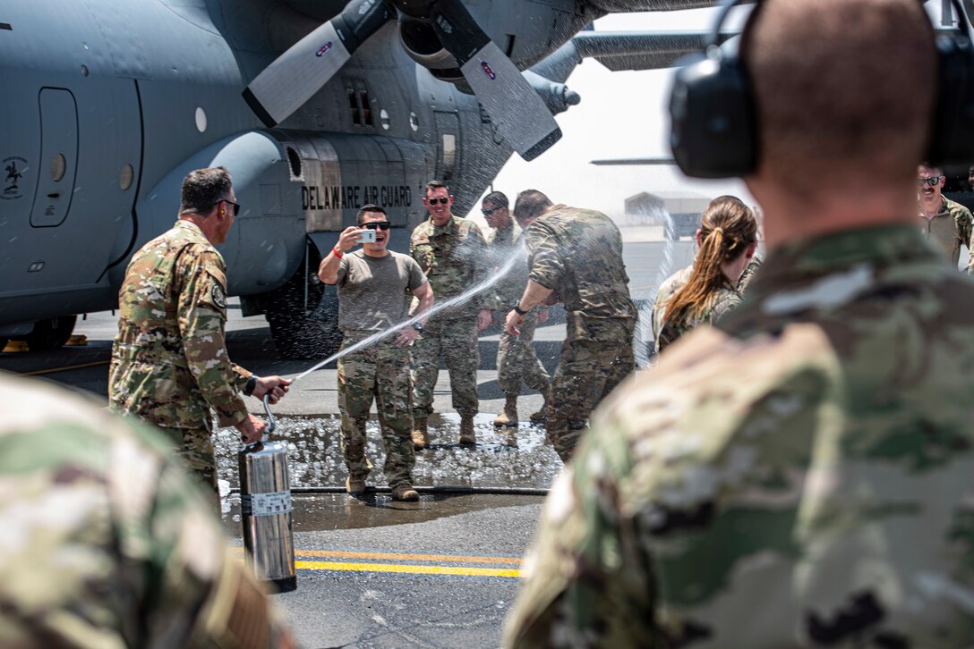 Members of the 386th Air Expeditionary Wing hose down Col. Philip Shea, 407th Air Expeditionary Group commander, after his “fini flight” at Ali Al Salem Air Base, Kuwait, July 4, 2021