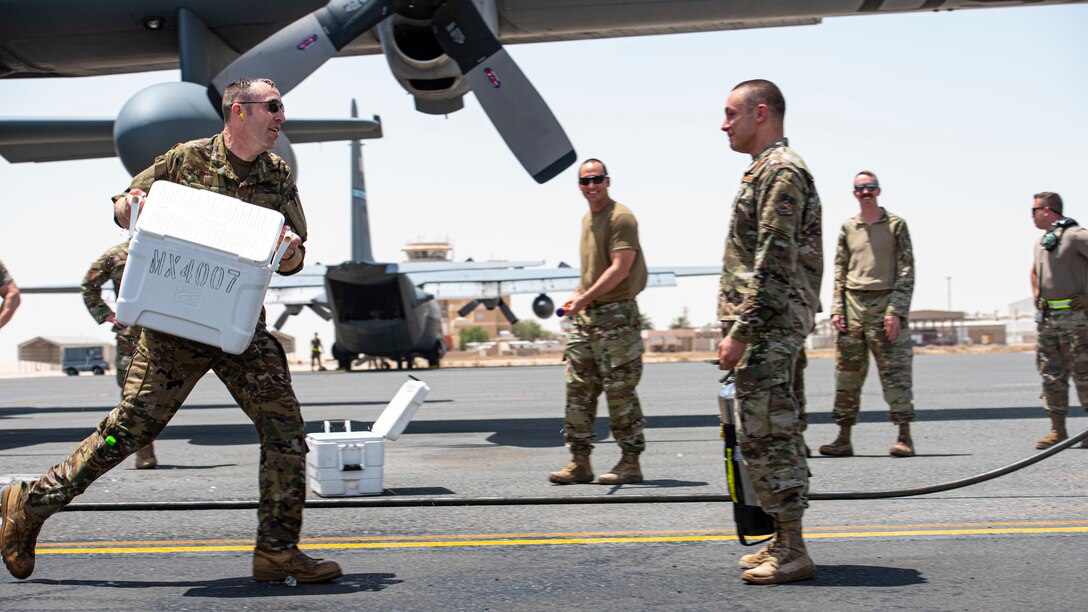 U.S. Air Force Col. Philip Shea, 407th Air Expeditionary Group commander, prepares to dump a cooler of ice water on Maj. Eric Connors, 386th Air Expeditionary Wing commander's executive officer, during his “fini flight” celebration at Ali Al Salem Air Base, Kuwait, July 4, 2021.