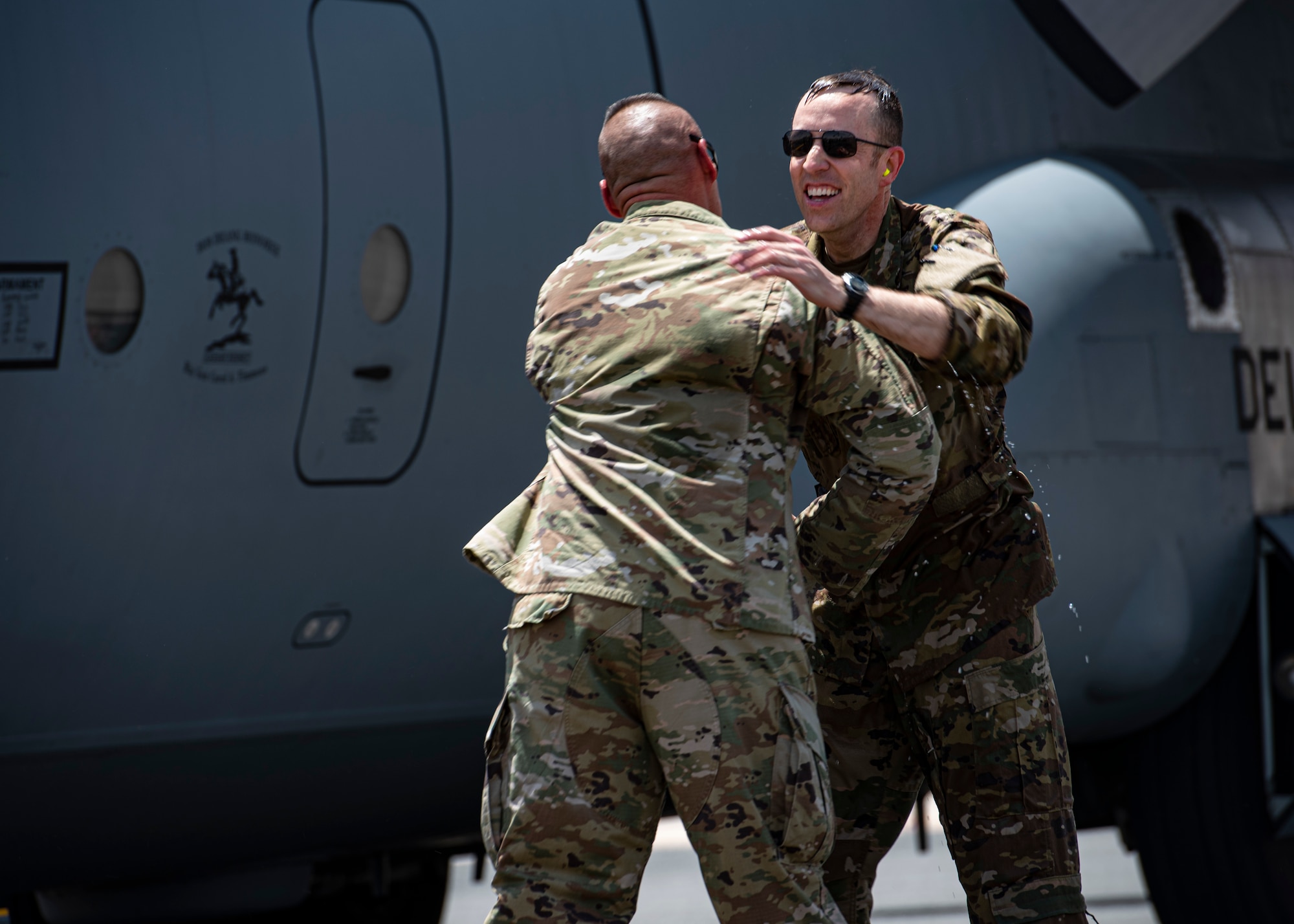 U.S. Air Force Col. Philip Shea, 407th Air Expeditionary Group commander, receives a hug on the flight line at Ali Al Salem Air Base, Kuwait, July 4, 2021
