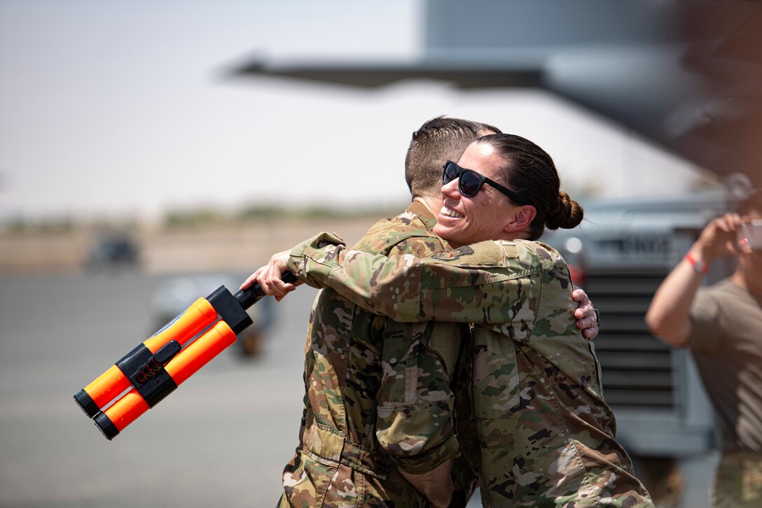 U.S. Air Force Col. Philip Shea, 407th Air Expeditionary Group commander, recieves a hug form Senior Master Sgt. Rebecca James, 407th AEG first sergeant on the flight line at Ali Al Salem Air Base, Kuwait, July 4, 2021.