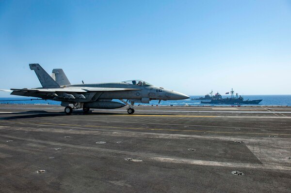 An F/A-18E Super Hornet fighter jet, attached to the "Rampagers" of Strike Fighter Squadron (VFA) 83, lands on the flight deck of aircraft carrier USS Dwight D. Eisenhower (CVN 69) as the ship conducts a passing exercise with guided-missile cruiser USS Vella Gulf (CG 72), left, and Egyptian Navy guided-missile frigate ENS Taba (FFG 916) in the Red Sea, June 29. The Eisenhower Carrier Strike Group is deployed to the U.S. 5th Fleet area of operations in support of naval operations to ensure maritime stability and security in the Central Region, connecting the Mediterranean and Pacific through the western Indian Ocean and three strategic choke points.