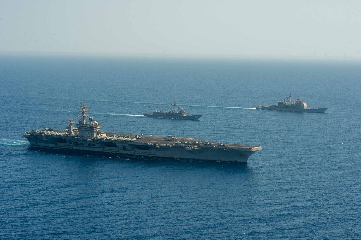Three ships sail on the ocean.